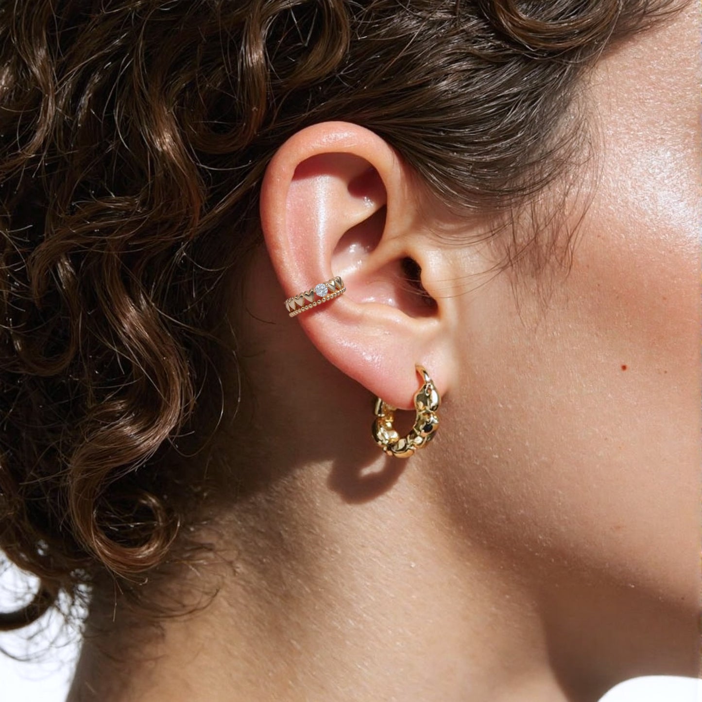 Minimalist 14K solid gold ear cuff earring modeled on a curved ear