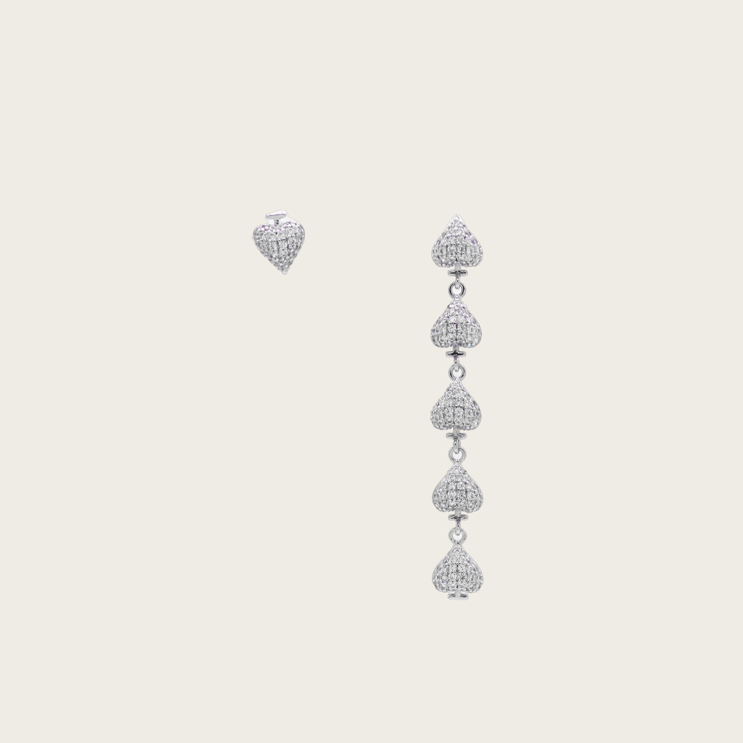 Gold plated asymmetric heart dangle earrings with zircon clusters, showcasing one solid heart and one clustered heart design on a model.