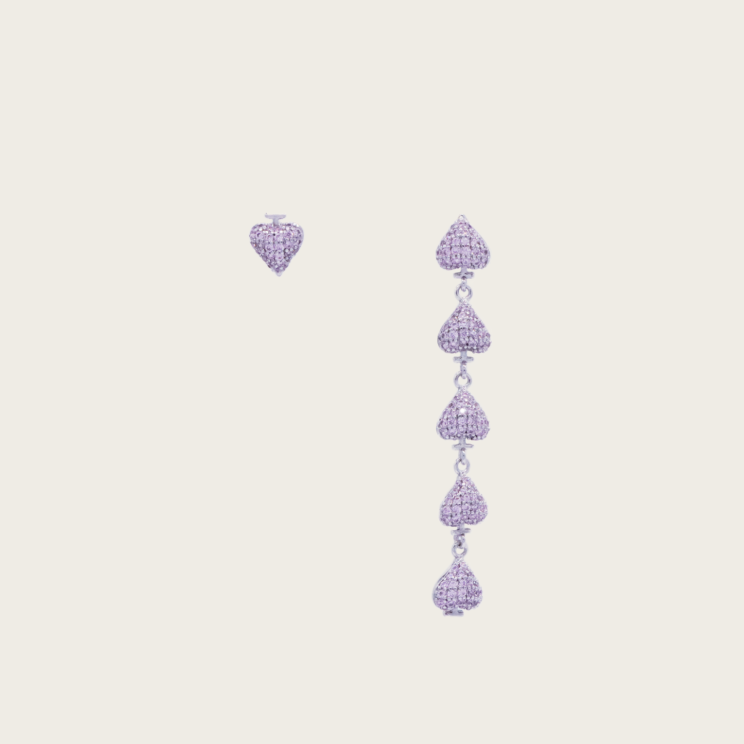 Gold plated asymmetric heart dangle earrings with zircon clusters, showcasing one solid heart and one clustered heart design on a model.