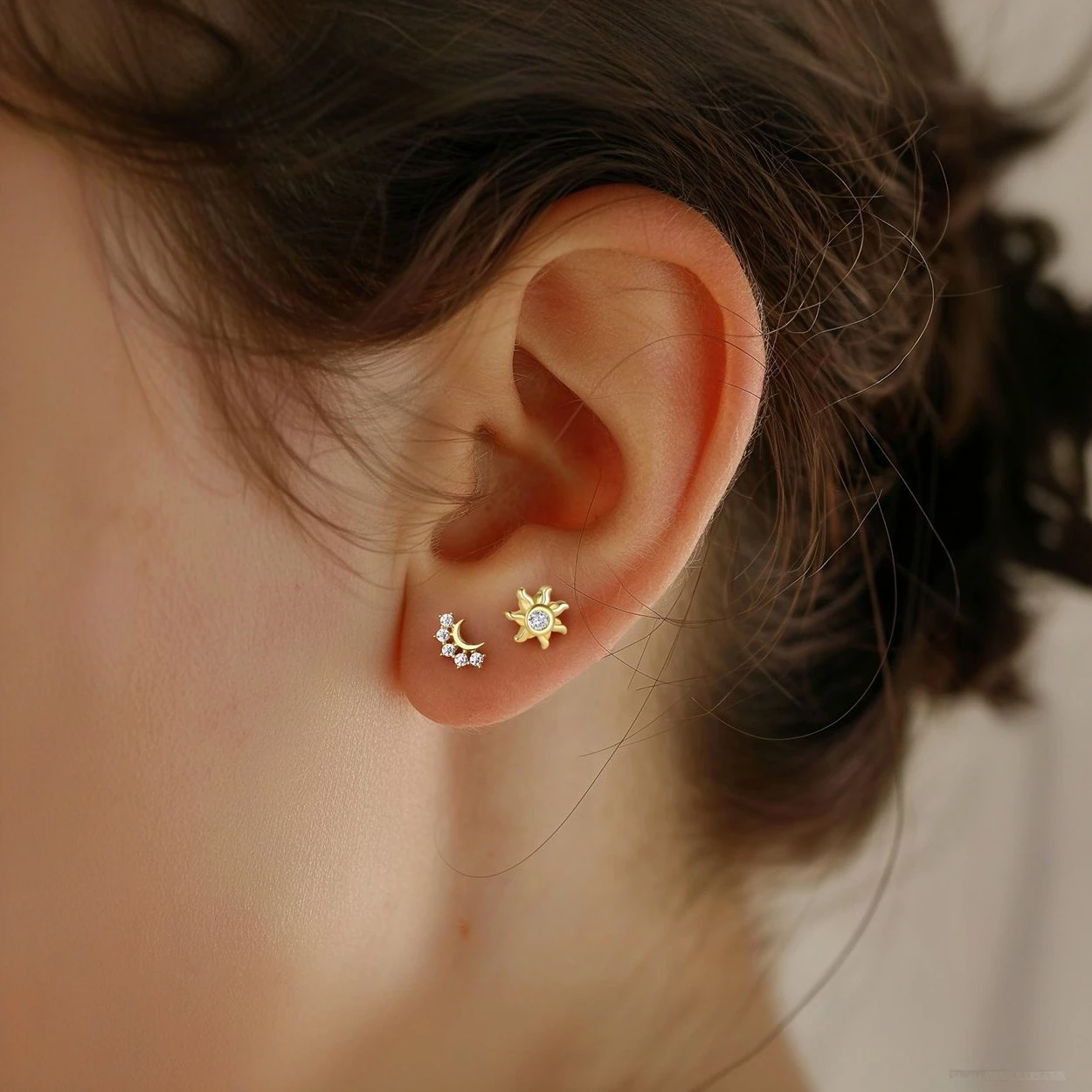 Ultra-petite 18K gold plated stud earrings on a model’s earlobe, showcasing minimalist shine.