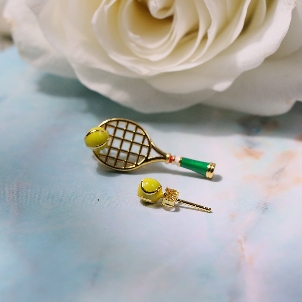 Trendy tennis-inspired mismatched earrings