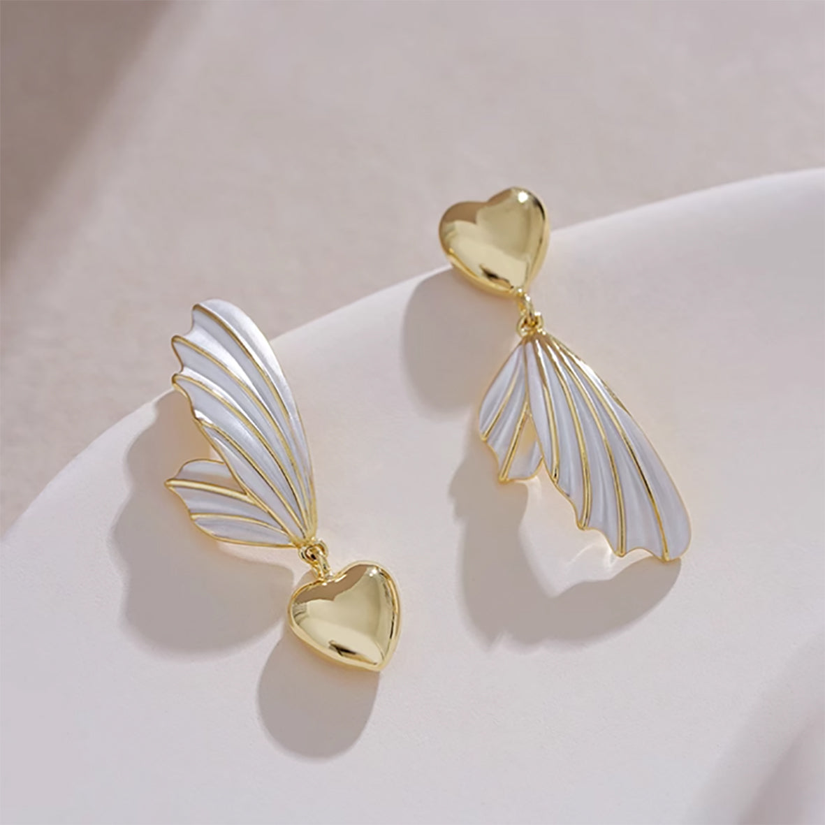 modern design earrings with wing accents