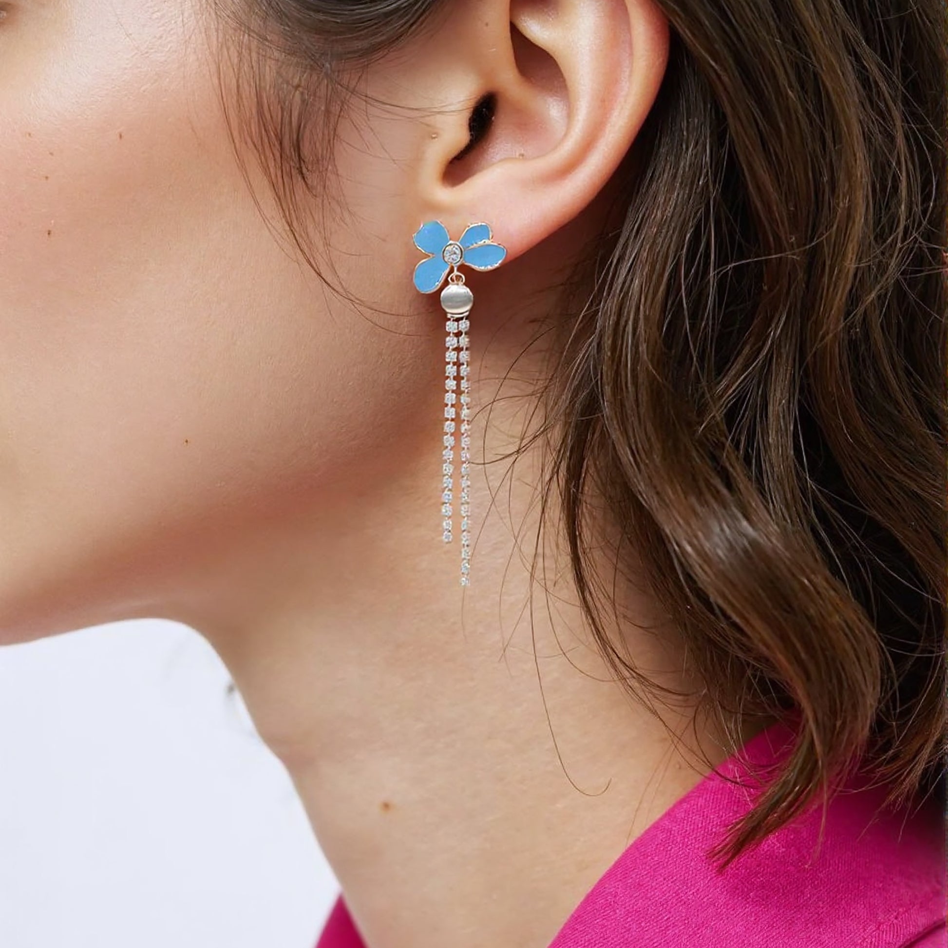 Gold plated asymmetric earrings with one floral cluster and one silk tassel