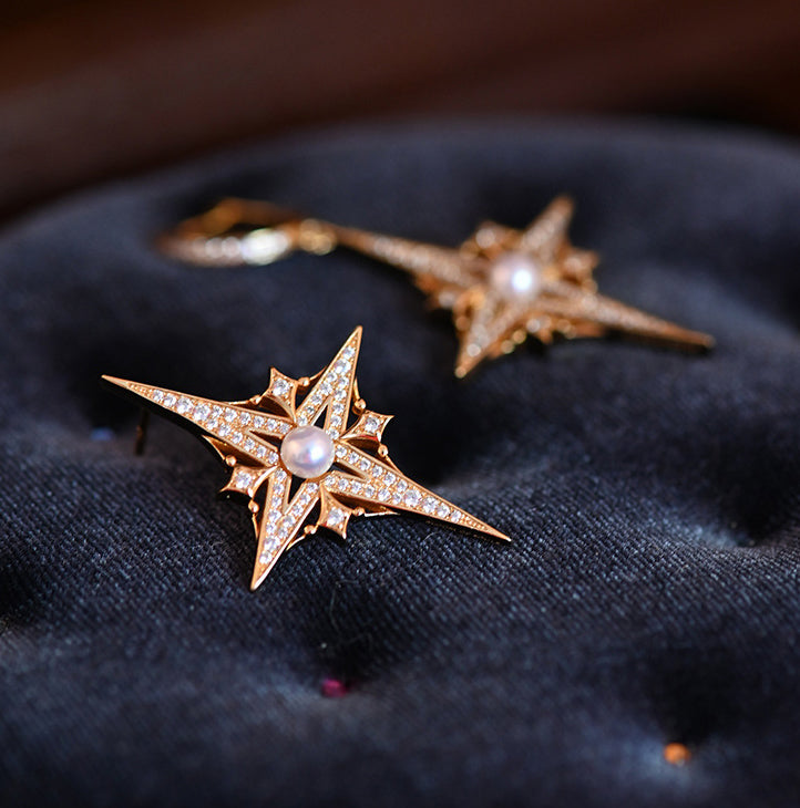 Asymmetric earrings featuring celestial-inspired design