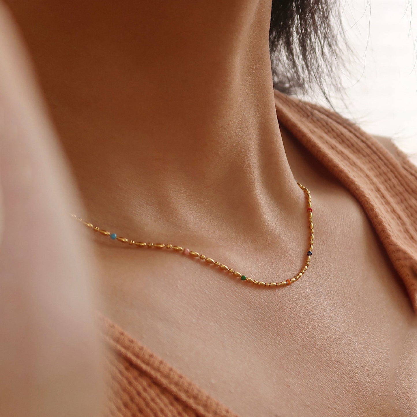 Beaded choker featuring vibrant enamel accents