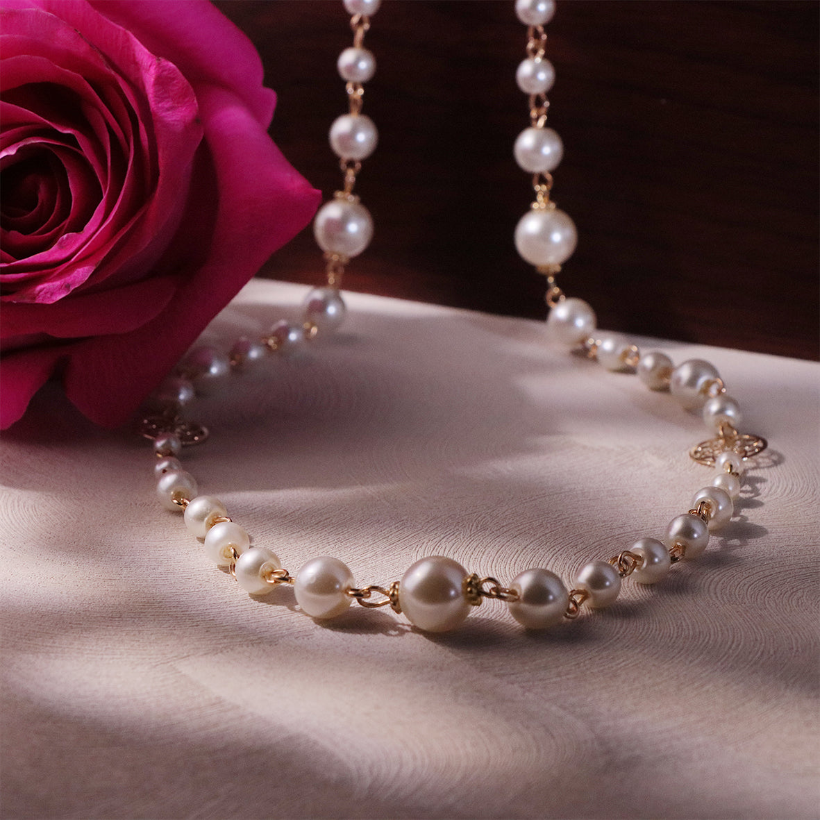 a stunning piece with a floral design and glass pearls, designed to add sophistication to your jewelry collection