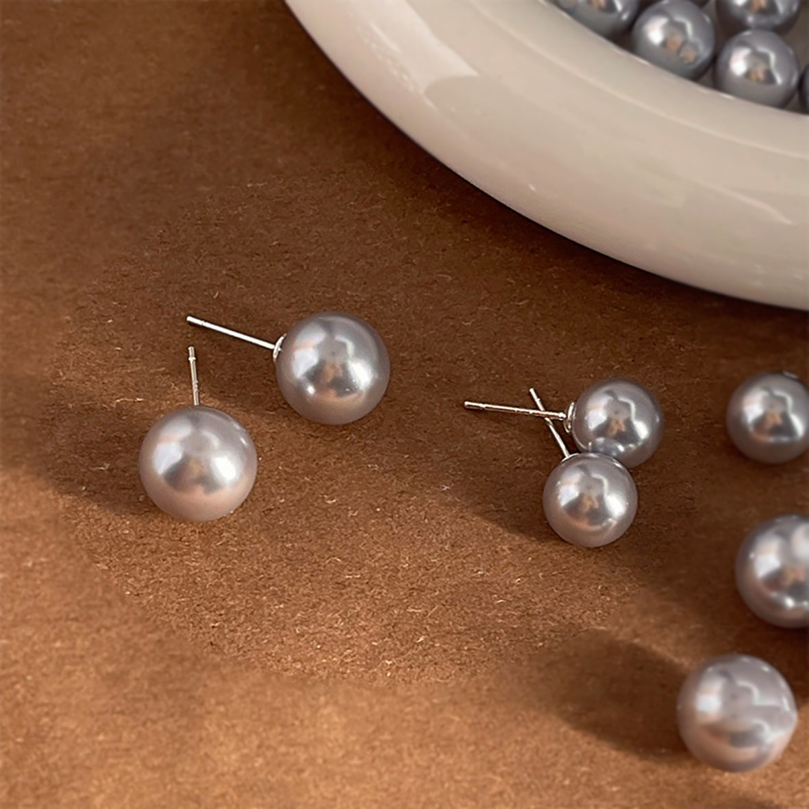 Simple gray glass pearl earrings with modern design