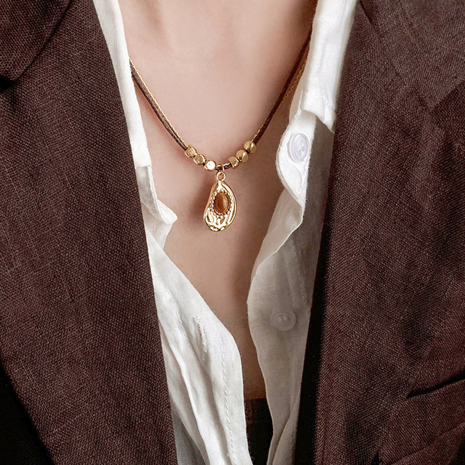 Handmade necklace featuring green tigerite beads strung on a natural cord