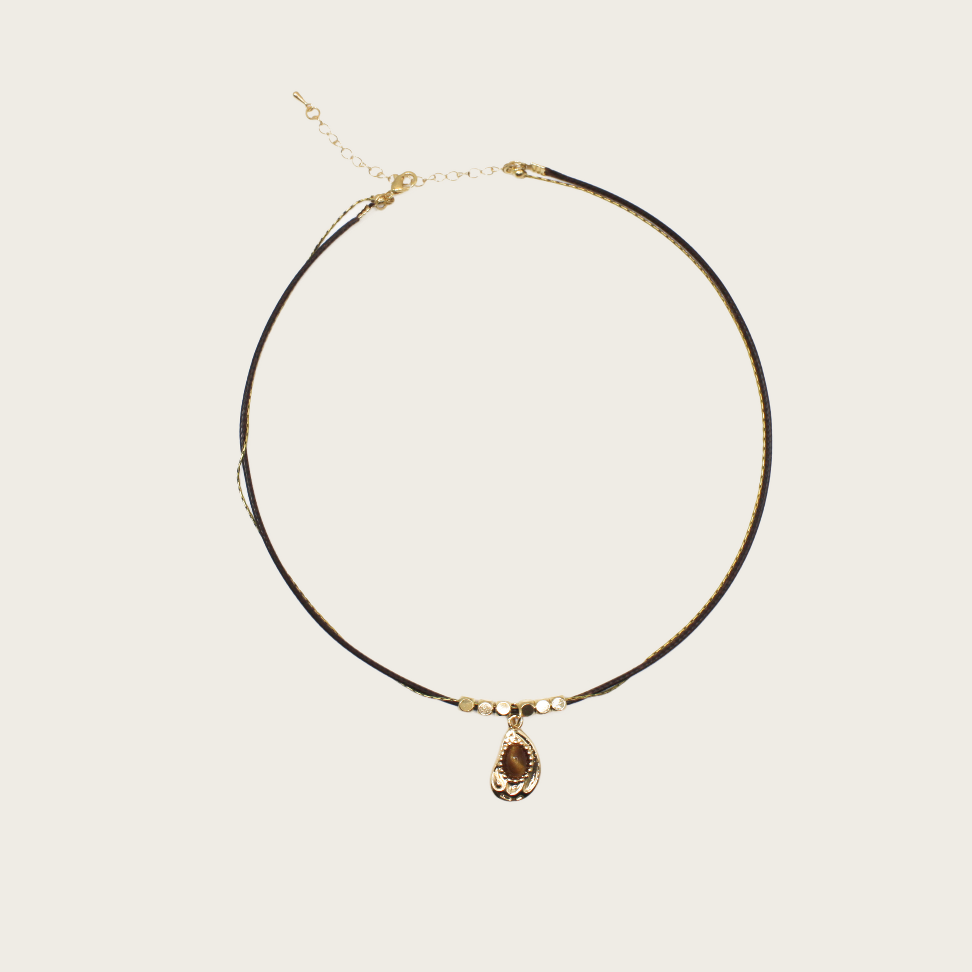 Handmade necklace featuring green tigerite beads strung on a natural cord