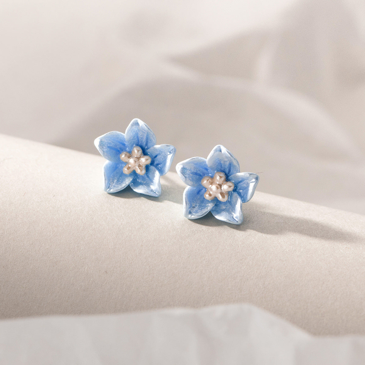 Elegant blue flower studs with subtle design