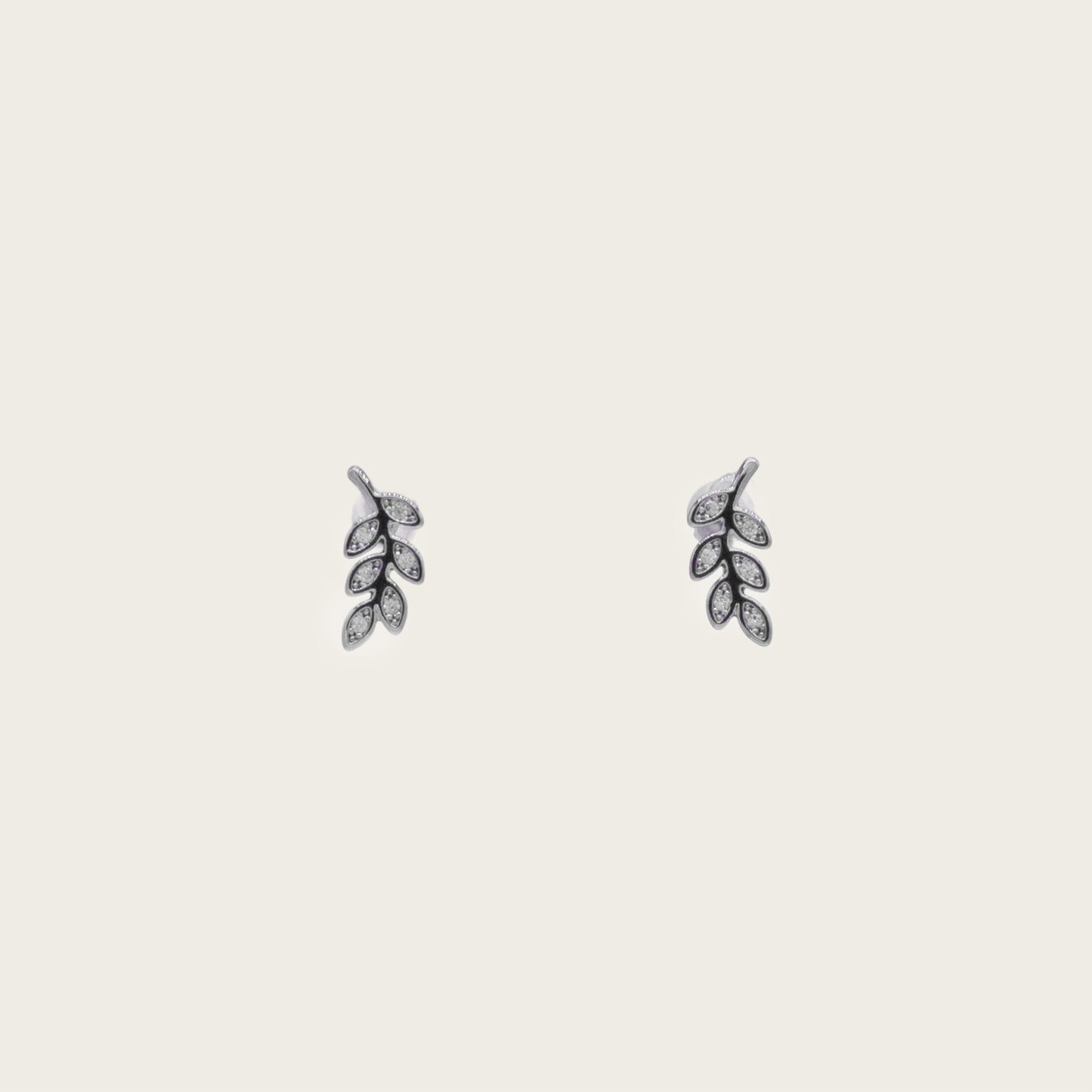 Tiny sterling silver leaf stud earrings with intricate detailing