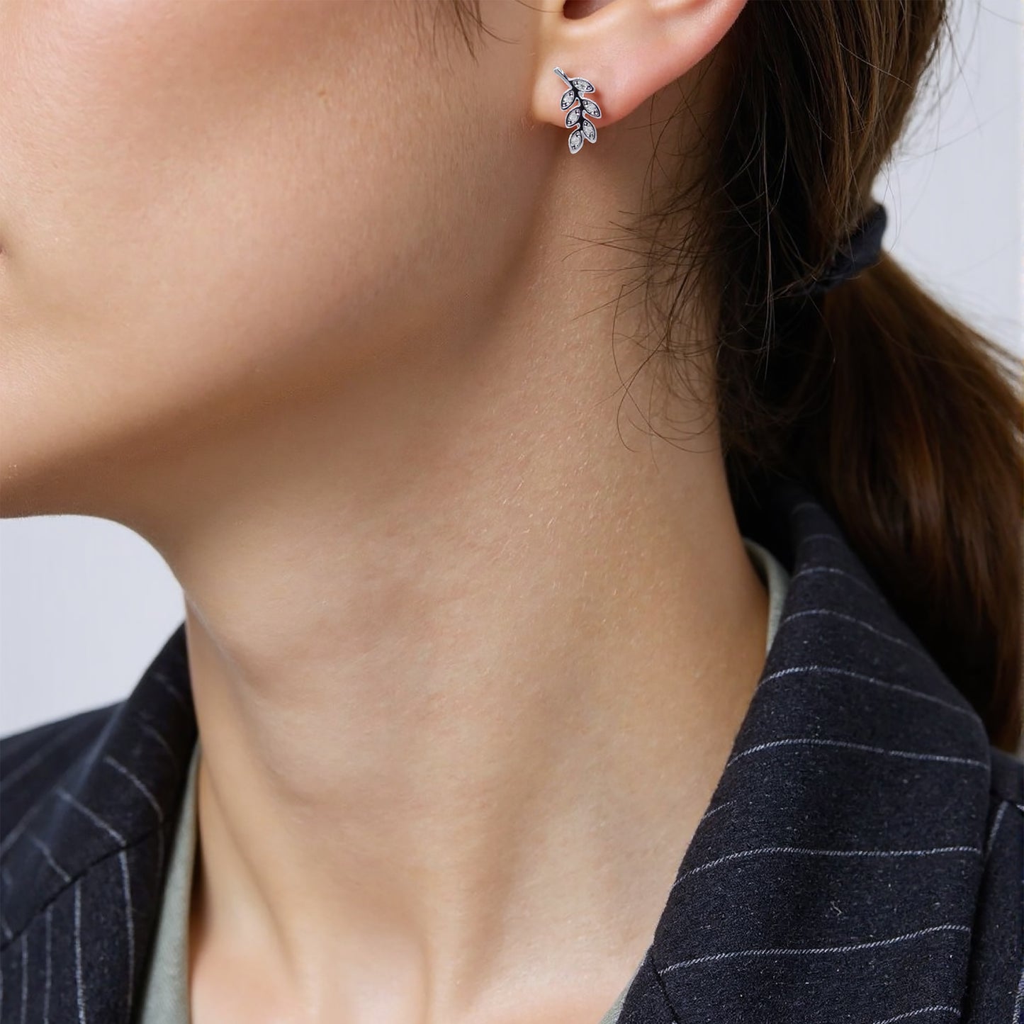 Tiny sterling silver leaf stud earrings with intricate detailingTiny sterling silver leaf stud earrings with intricate detailing