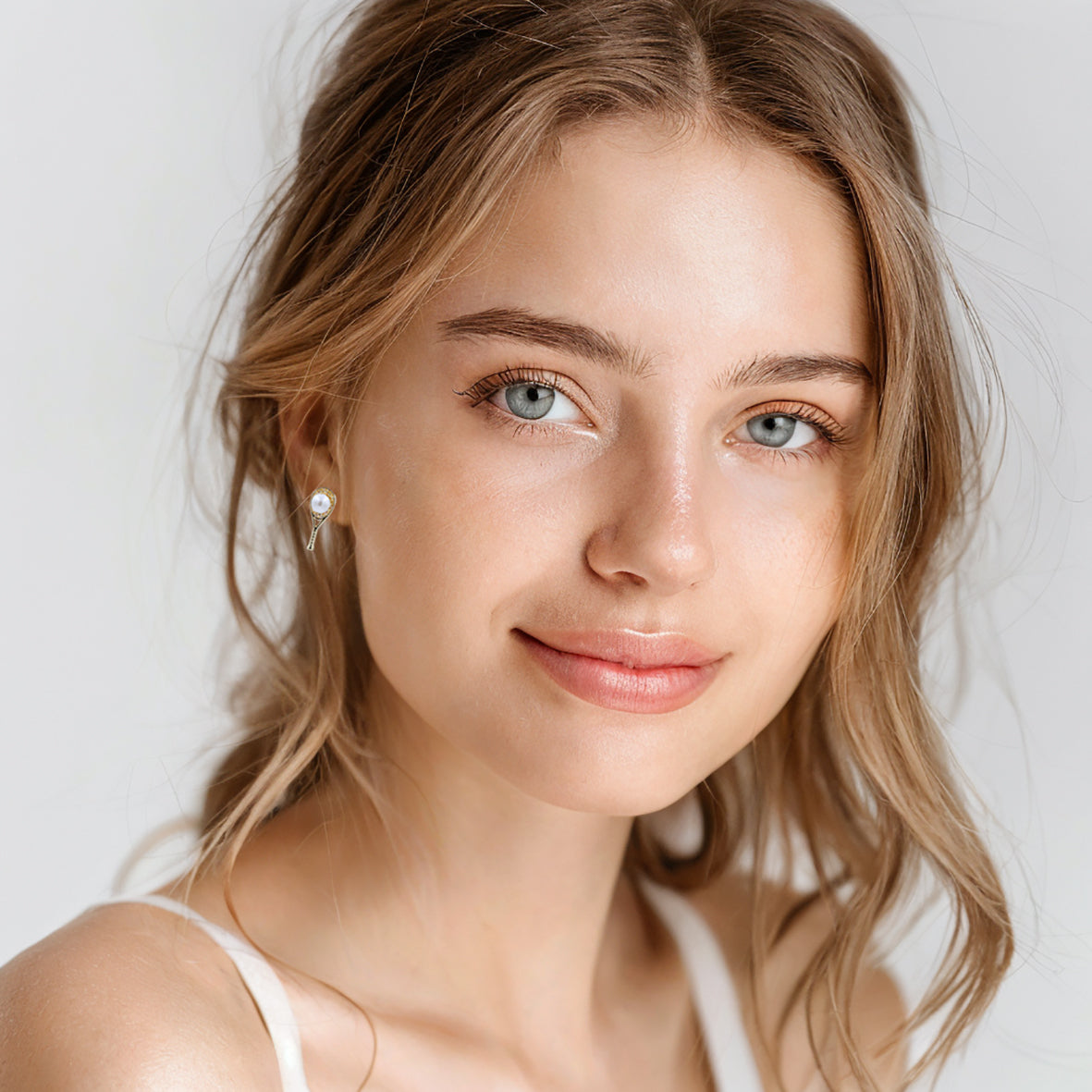 Elegant tennis racket stud earrings with pearl accents