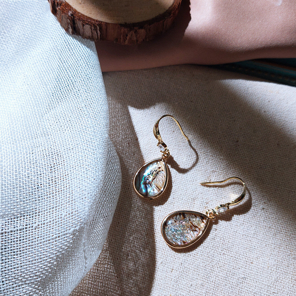 Charming earrings featuring natural shell water drop.