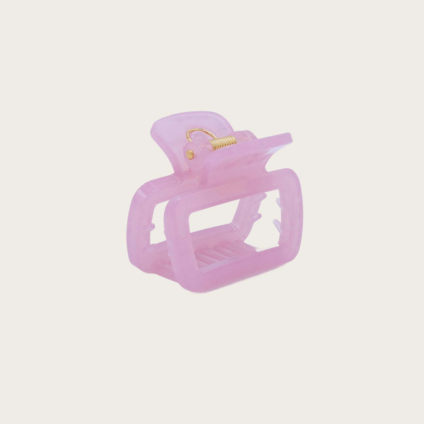 Set of pastel-colored rectangular hair claw clips in pink, mint, and lavender, styled on a wavy half-up hairstyle.