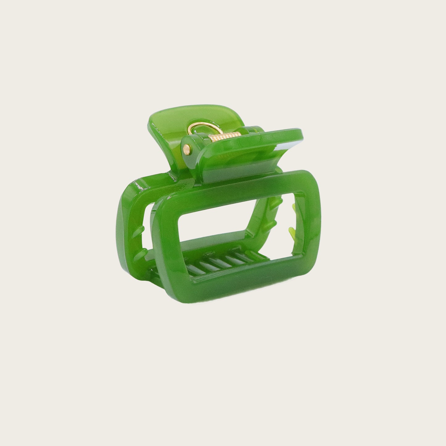 Set of pastel-colored rectangular hair claw clips in pink, mint, and lavender, styled on a wavy half-up hairstyle.