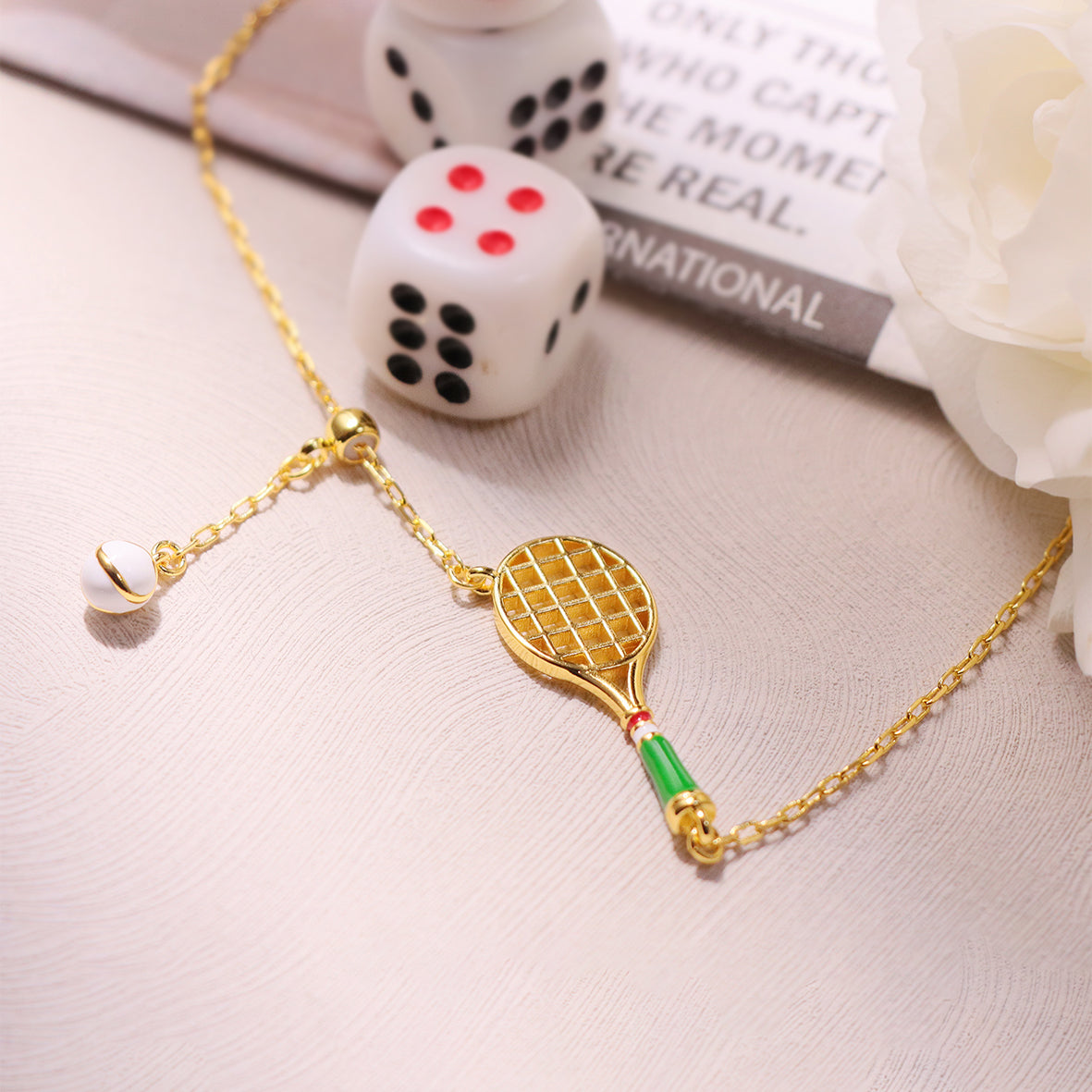 Close-up of a Tennis Racket Charm Necklace, showcasing the intricate design of the tennis racket pendant on a sleek chain