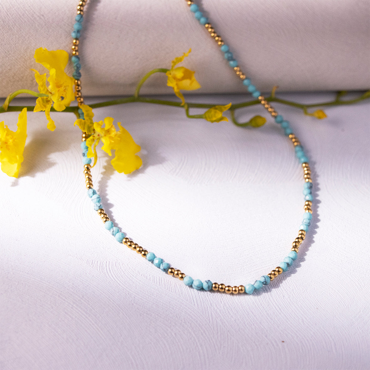 Elegant turquoise bead necklace with French charm.