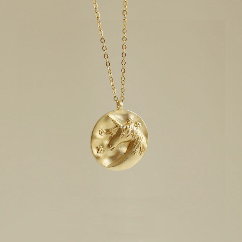 Unique sweater necklace featuring unicorn coin charm