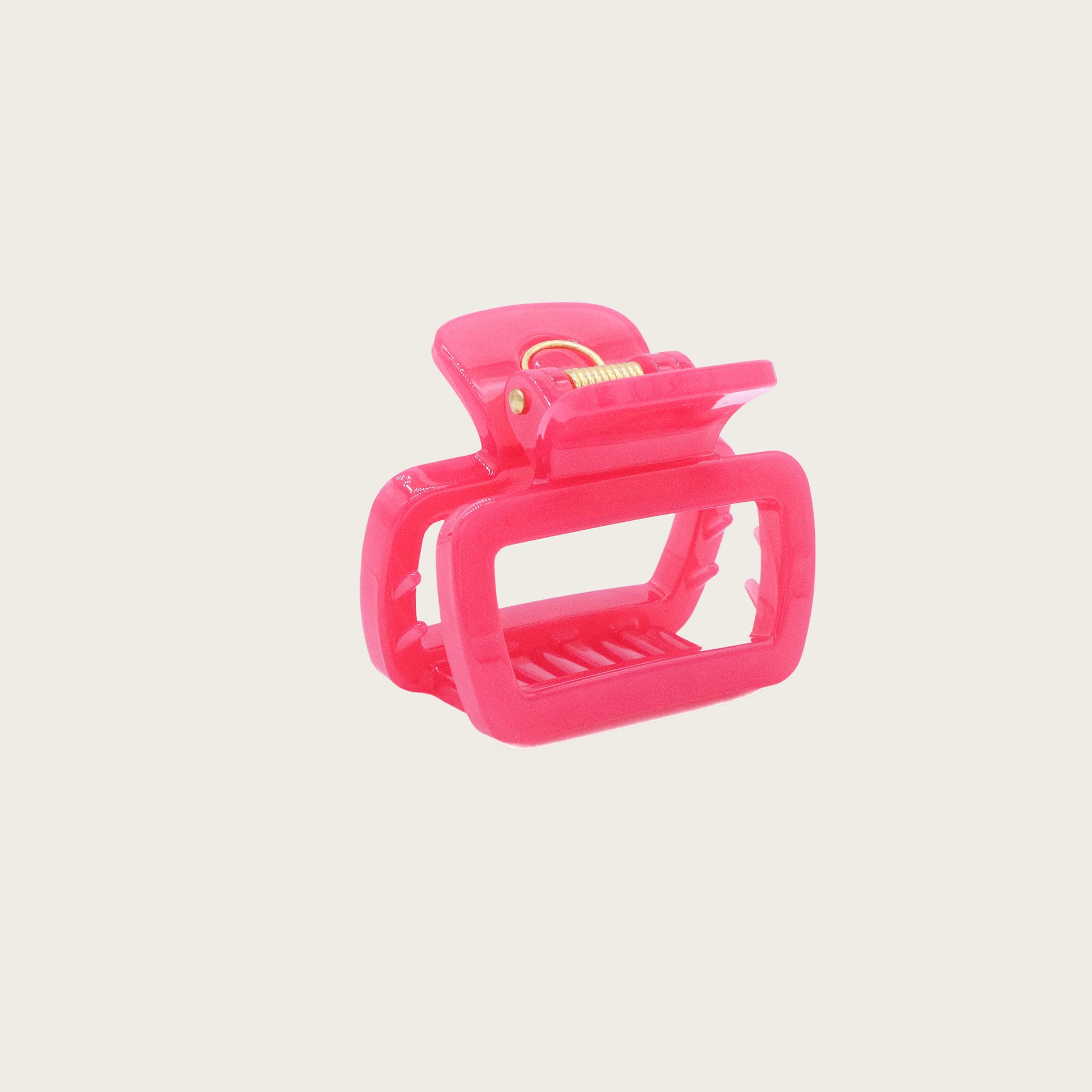 Set of pastel-colored rectangular hair claw clips in pink, mint, and lavender, styled on a wavy half-up hairstyle.